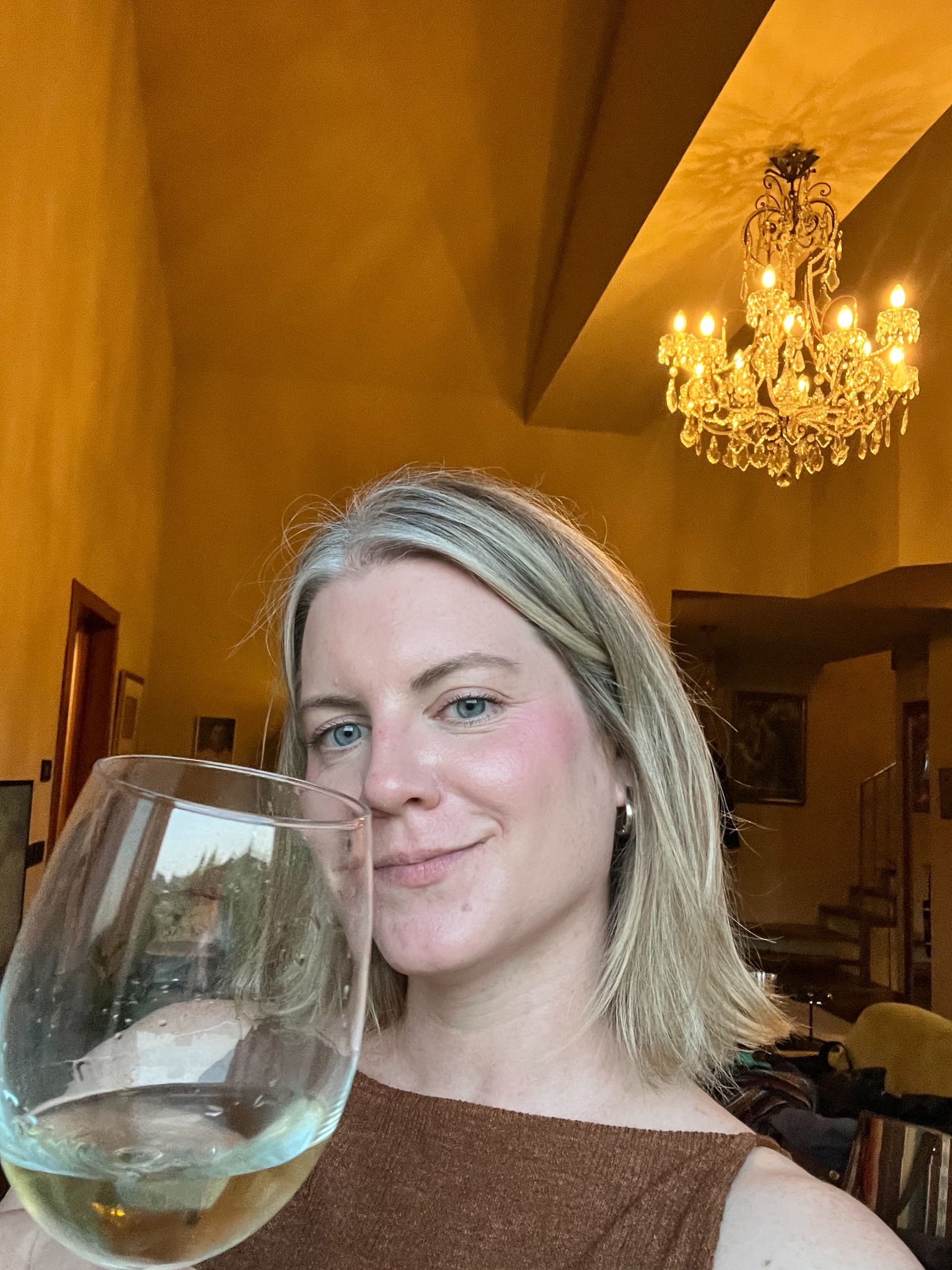 Molly enjoying wine in an elegant hospitality setting