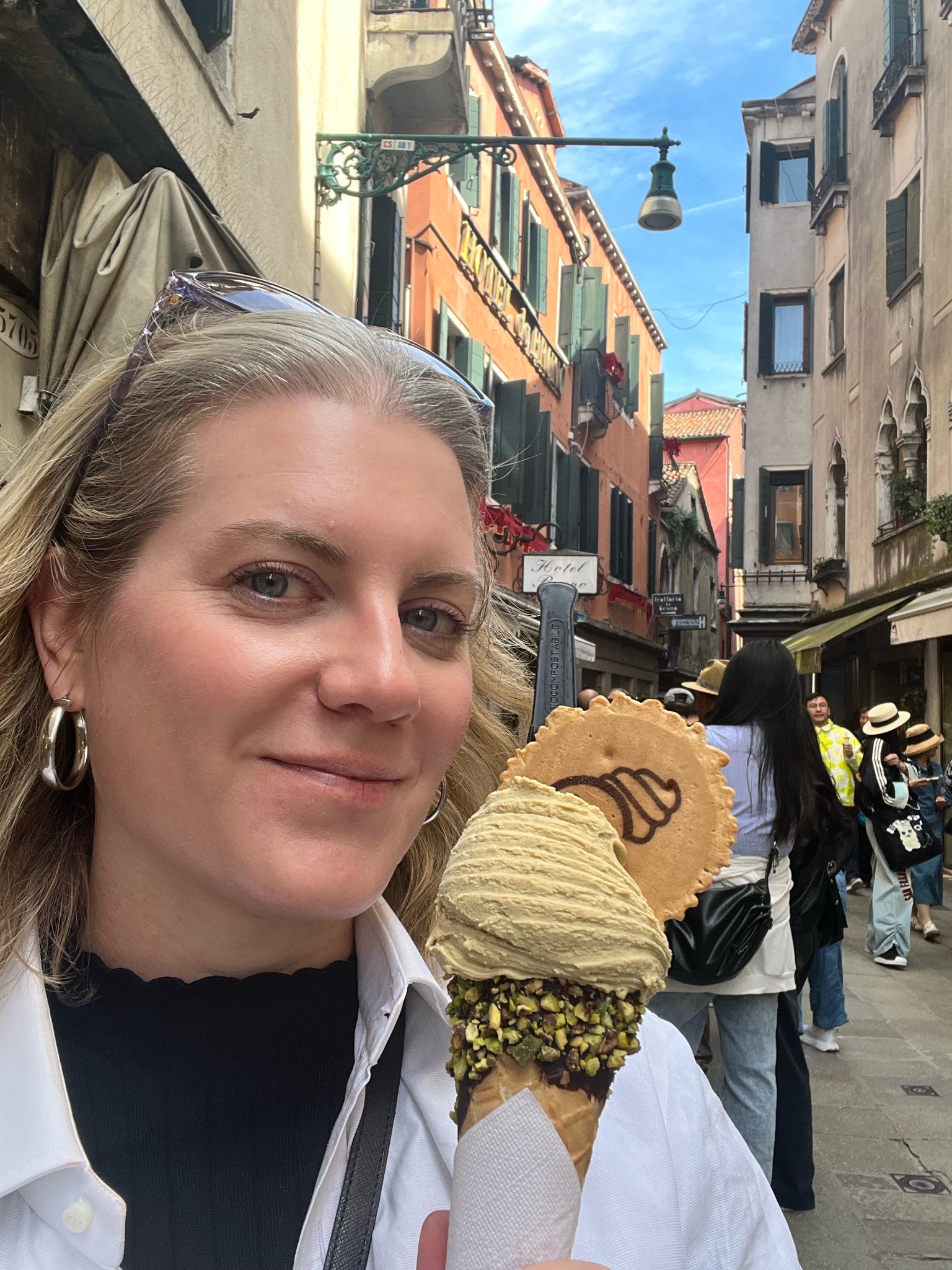 Molly eating gelato on a sunny street in Venice